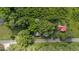 Overhead view showing the red roofed property nestled amongst lush green trees at 1908 Rocky Cross Rd, Zebulon, NC 27597