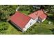 Charming home showcasing a durable red metal roof and verdant surroundings at 1908 Rocky Cross Rd, Zebulon, NC 27597