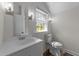Bright bathroom features a modern vanity with a sink and a new toilet at 1908 Rocky Cross Rd, Zebulon, NC 27597