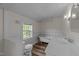 Updated bathroom featuring a clawfoot tub, modern vanity, and a window providing natural light at 1908 Rocky Cross Rd, Zebulon, NC 27597