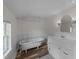 Well-lit bathroom boasts a clawfoot tub, updated vanity, and ample natural light from the window at 1908 Rocky Cross Rd, Zebulon, NC 27597