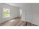 Cozy bedroom features new wood floors and an adjacent doorway at 1908 Rocky Cross Rd, Zebulon, NC 27597