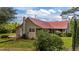 Charming home featuring a durable red metal roof, deck and well-maintained lawn at 1908 Rocky Cross Rd, Zebulon, NC 27597