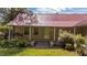Charming home featuring a durable red metal roof, front porch and well-maintained lawn at 1908 Rocky Cross Rd, Zebulon, NC 27597