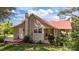 Charming home featuring a durable red metal roof, deck and well-maintained lawn at 1908 Rocky Cross Rd, Zebulon, NC 27597