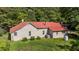 Quaint home with a striking red roof, nestled amidst a lush green landscape at 1908 Rocky Cross Rd, Zebulon, NC 27597