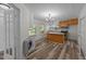 Bright kitchen with an island, wood cabinets, wood floors, and modern appliances at 1908 Rocky Cross Rd, Zebulon, NC 27597
