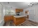 Kitchen with an island, stainless steel appliances, laminate flooring and bright light at 1908 Rocky Cross Rd, Zebulon, NC 27597