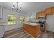 Bright kitchen features stainless appliances, an island, and natural light at 1908 Rocky Cross Rd, Zebulon, NC 27597