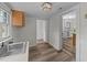 The laundry room leads to the dining room with laminate floors, white walls, and cabinets at 1908 Rocky Cross Rd, Zebulon, NC 27597