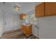 Bright laundry room featuring laminate floors, sink, white walls, and cabinets at 1908 Rocky Cross Rd, Zebulon, NC 27597