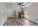 Spacious living room with a brick fireplace, ceiling fan, and attractive wood floors at 1908 Rocky Cross Rd, Zebulon, NC 27597