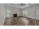 Spacious living room with wood floors, a brick fireplace, and large windows that provide plenty of natural light at 1908 Rocky Cross Rd, Zebulon, NC 27597