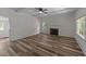 Spacious living room boasts a fireplace, wood floors, and great natural light at 1908 Rocky Cross Rd, Zebulon, NC 27597