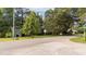 View of the home's lot with mature trees and roadside access at 1908 Rocky Cross Rd, Zebulon, NC 27597