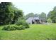 Lush backyard with mature landscaping, offering a tranquil and private outdoor retreat at 2006 N Ashland Dr, Burlington, NC 27217