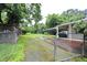 Spacious backyard featuring a covered patio, storage shed, and lush greenery at 2006 N Ashland Dr, Burlington, NC 27217