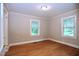 Bedroom with hardwood floors and natural light from two windows at 2006 N Ashland Dr, Burlington, NC 27217