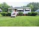 Charming single-story home with white siding, orange door, and well-maintained front yard at 2006 N Ashland Dr, Burlington, NC 27217