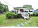 A cozy home with white siding, landscaped yard, and a welcoming front porch at 2006 N Ashland Dr, Burlington, NC 27217