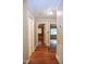 Hallway featuring hardwood floors, neutral paint, and access to multiple rooms at 2006 N Ashland Dr, Burlington, NC 27217