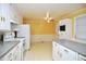 Eat-in kitchen offers white appliances, white cabinets and plenty of counter space at 2006 N Ashland Dr, Burlington, NC 27217