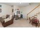 Cozy finished basement featuring a comfortable sofa, desk, and adjacent staircase at 227 Kenmont Dr, Holly Springs, NC 27540