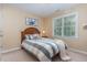 Relaxing bedroom features a comfortable bed, plush linens, and lots of natural light at 227 Kenmont Dr, Holly Springs, NC 27540