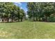 Spacious common area features mature trees and lush lawn providing serene views for residents at 227 Kenmont Dr, Holly Springs, NC 27540