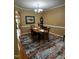 Inviting dining room with an oval table, chandelier, and decorative rug at 227 Kenmont Dr, Holly Springs, NC 27540