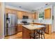 Bright kitchen with wood cabinets, stainless steel appliances, granite countertops, and a functional center island at 227 Kenmont Dr, Holly Springs, NC 27540