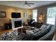 Cozy living room with fireplace, ceiling fan, and comfortable seating at 227 Kenmont Dr, Holly Springs, NC 27540