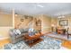 Inviting living room features hardwood floors, a cozy couch, stylish decor, and staircase access at 227 Kenmont Dr, Holly Springs, NC 27540