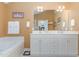 Spacious bathroom features dual vanities, a soaking tub, and plenty of storage at 227 Kenmont Dr, Holly Springs, NC 27540