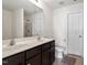 Bright bathroom features a double sink vanity and a separate toilet and shower at 228 Botanical Ct, Bunnlevel, NC 28323