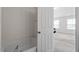 Bright bathroom features a soaking tub and view into the bedroom at 228 Botanical Ct, Bunnlevel, NC 28323