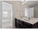 Bathroom features a double sink vanity and access to the bedroom at 228 Botanical Ct, Bunnlevel, NC 28323
