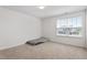 Carpeted bedroom featuring neutral paint and a large window at 228 Botanical Ct, Bunnlevel, NC 28323