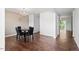 Inviting dining room with hardwood floors, a modern chandelier, and a view to the back yard at 228 Botanical Ct, Bunnlevel, NC 28323