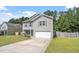Charming two-story home featuring gray siding, a well-manicured lawn, and an attached garage at 228 Botanical Ct, Bunnlevel, NC 28323