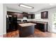 Spacious kitchen with dark wood cabinets and stainless-steel appliances at 228 Botanical Ct, Bunnlevel, NC 28323