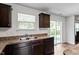 Well-lit kitchen featuring stainless steel sink, brown cabinets and countertops, and sliding glass doors at 228 Botanical Ct, Bunnlevel, NC 28323