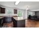 Kitchen with an island, dark cabinets, and lots of natural light at 228 Botanical Ct, Bunnlevel, NC 28323