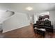 Spacious open floor plan with hardwood floors and comfortable leather seating at 228 Botanical Ct, Bunnlevel, NC 28323