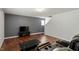 Cozy living room featuring hardwood floors, neutral paint, entertainment center, and comfortable seating at 228 Botanical Ct, Bunnlevel, NC 28323