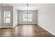 Dining room with hardwood floors, natural light, and modern chandelier at 260 Pretty Run Branch Ln, Wendell, NC 27591