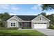 Charming one-story home with stone accents, gray siding, well-manicured lawn and an attached two-car garage at 260 Pretty Run Branch Ln, Wendell, NC 27591