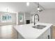 Bright and modern kitchen featuring a large kitchen island, view to a fireplace and hardwood floors at 260 Pretty Run Branch Ln, Wendell, NC 27591