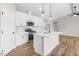 Bright kitchen with stainless steel appliances, white cabinets, quartz countertops, and an island at 260 Pretty Run Branch Ln, Wendell, NC 27591