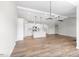 Spacious open-concept living area featuring hardwood floors and white paint with kitchen view at 260 Pretty Run Branch Ln, Wendell, NC 27591